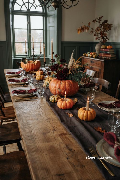 Halloween dining table decor with pumpkin vases votive holders and autumn floral centerpiece