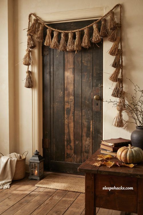 Halloween doorframe decor with handmade broomstick garland and witchy entryway