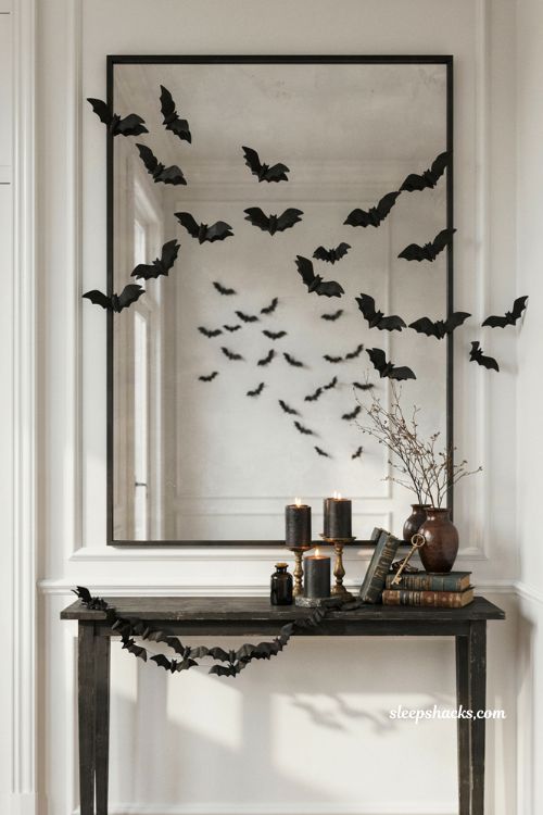 Halloween entryway console decor with flying bats mirror and black candles