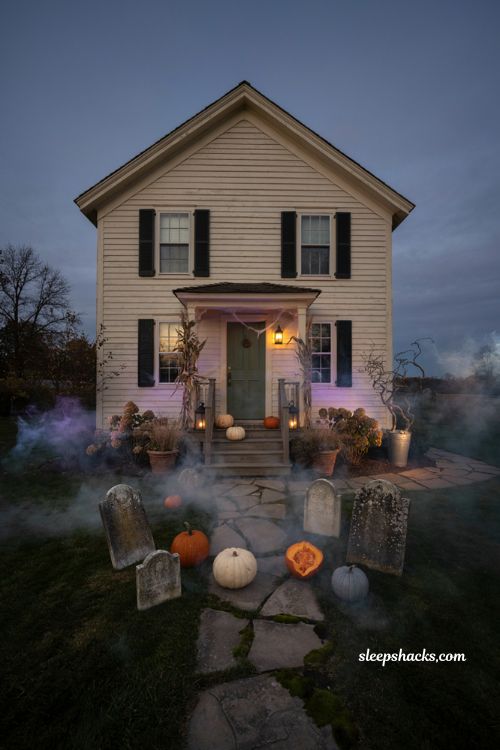 Halloween fog machine atmosphere with glowing tombstones purple uplighting and spooky front yard decor