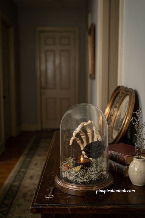 Halloween hallway ideas with apothecary glass dome skeleton hand black rose and vintage decor