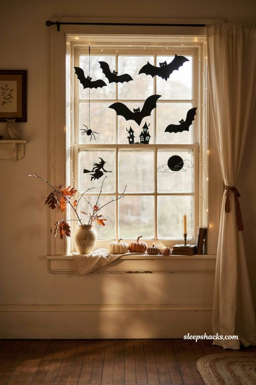 Halloween window display ideas with cozy vintage pumpkin decor and spooky silhouettes