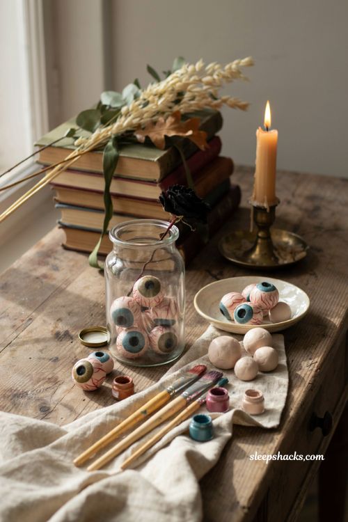 Handmade clay eyeballs in a vintage glass jar for Halloween decor
