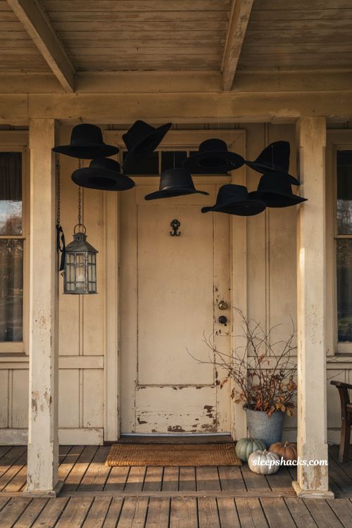 Hanging witch hats at different heights for a cheap Halloween porch decoration 