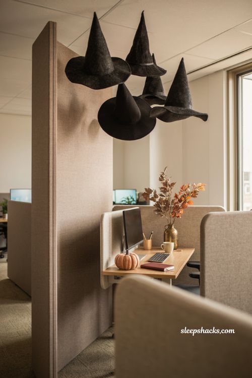 Hanging witch hats floating over an office cubicle entrance for Halloween decor