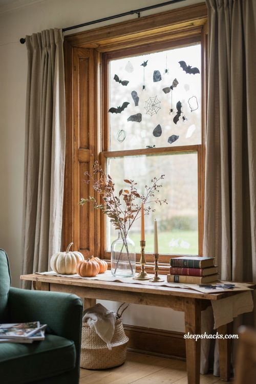 Homemade Halloween window clings with bats spiders and webs on glass