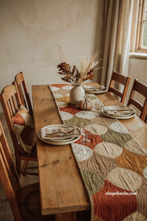 Hourglass fall table runner with warm autumn quilt blocks