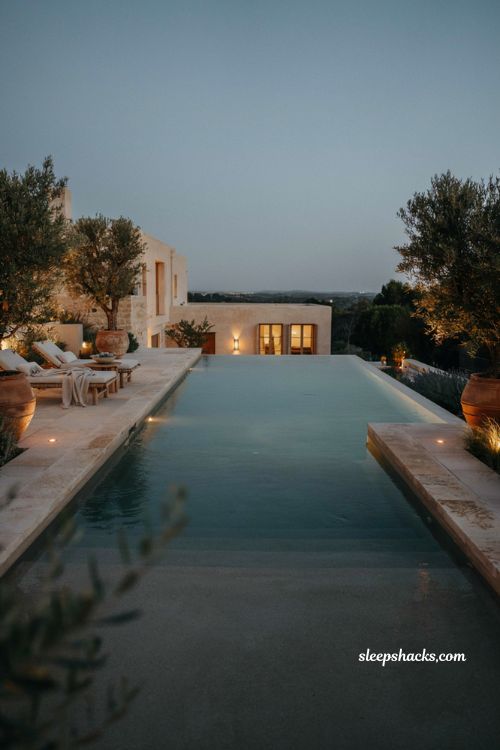 Infinity pool ideas with underwater LED lighting at night
