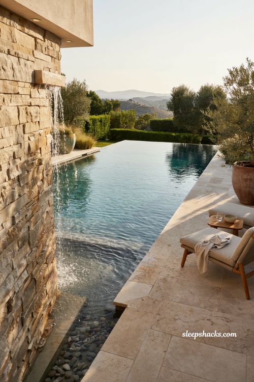 Infinity pool with waterfall wall for modern backyard