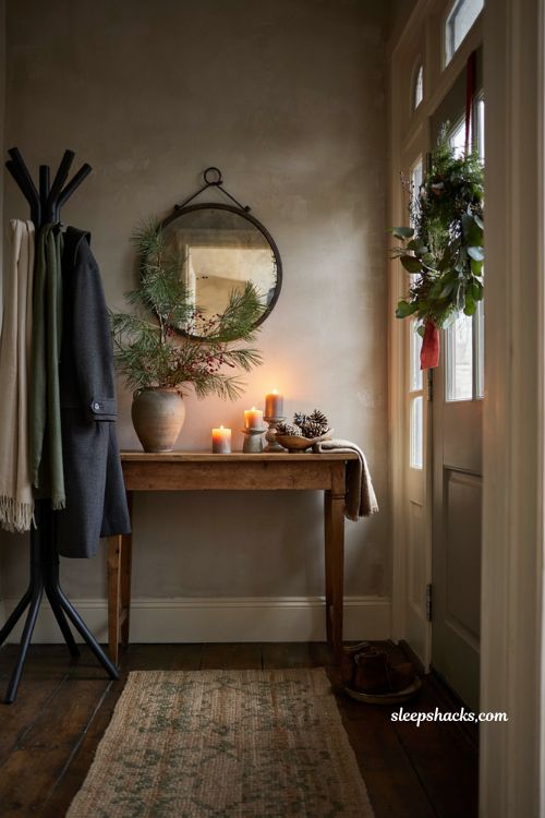 Inviting christmas entryway decor idea with console table greenery candles and wreath for holiday home