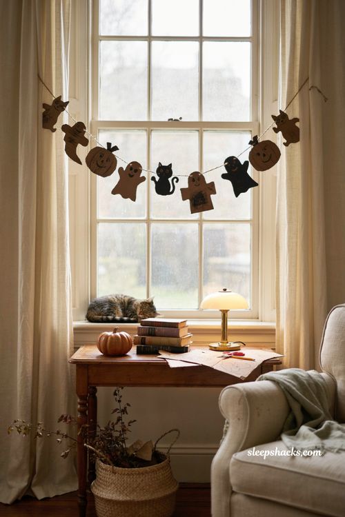 Kid designed Halloween character garland DIY with handmade ghosts cats and pumpkins