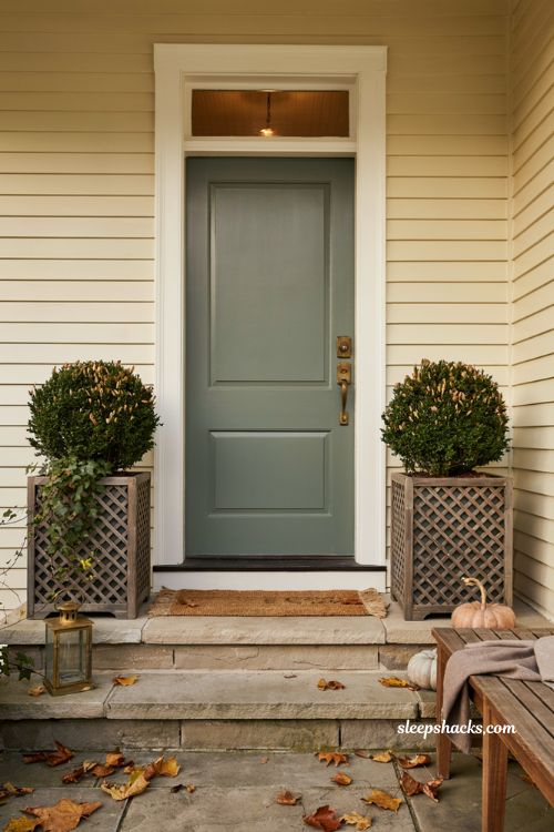 Lattice square planters with boxwood spheres for an elegant fall front porch