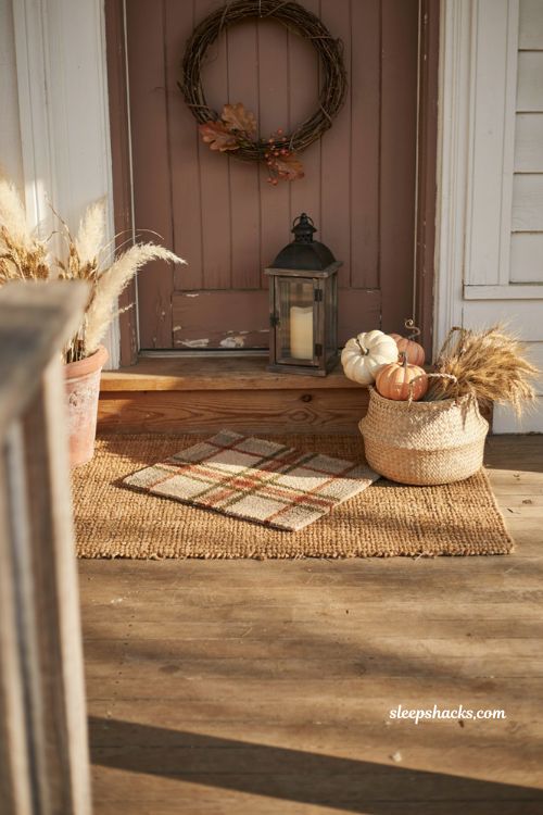 Layered fall doormat entryway with coir mat seasonal plaid rug pumpkins and rustic decor