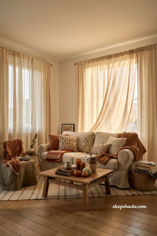 Layered throw blanket ideas for a cozy fall living room with warm autumn textures