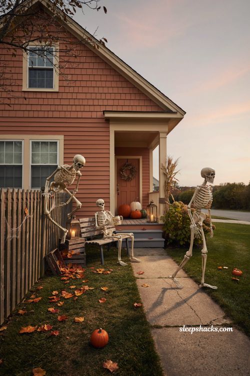 Life size skeleton Halloween yard scene with posable skeletons pumpkins and cozy autumn decor