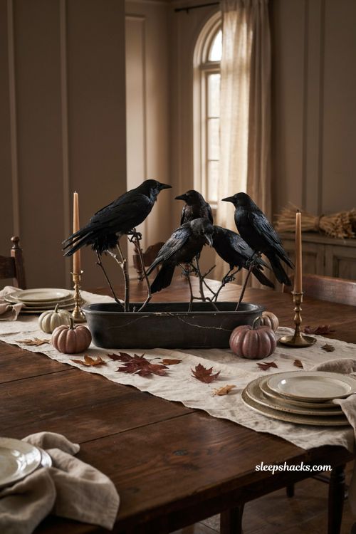 Lifelike black crows perched on branches in a low vase for elegant gothic Halloween centerpiece decor