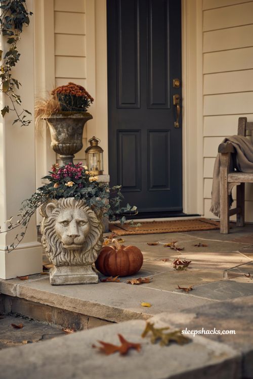 Lion head accent planter with fall flowers for elegant front porch decor