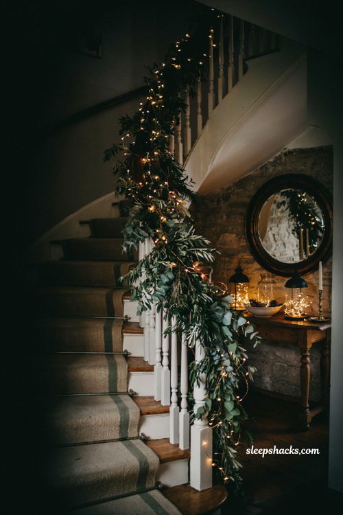 Magical twinkling fairy light and eucalyptus garland on a festive christmas staircase for a cozy home