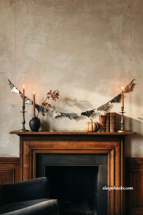 Metallic bat banner Halloween garland on a vintage fireplace mantel 