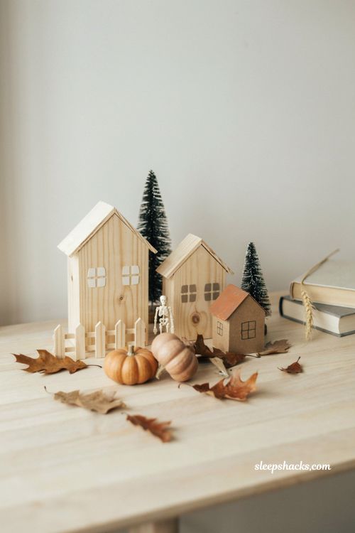 Minimal unfinished wood and paper Halloween village with neutral autumn decor 