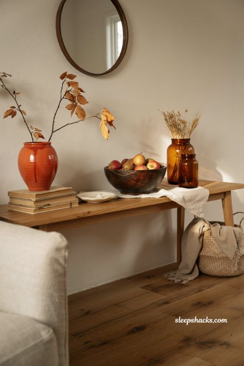 Minimalist fall decor using items you already own with amber glass dark wood and earthy accents 