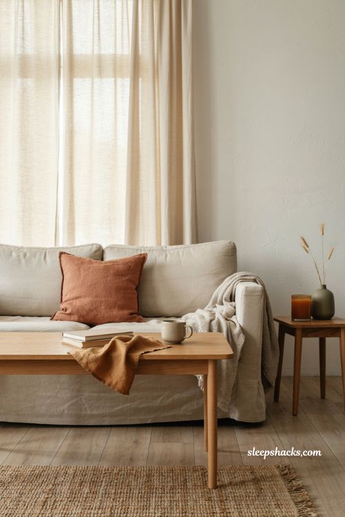 Minimalist fall decor with neutral living room and subtle rust caramel olive accents 