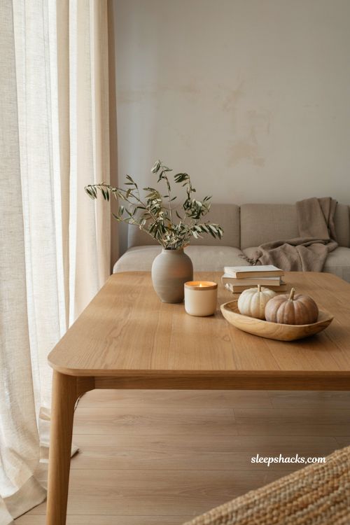 Minimalist roasted pumpkin and ginger candle styling in a cozy neutral living room with Japandi decor