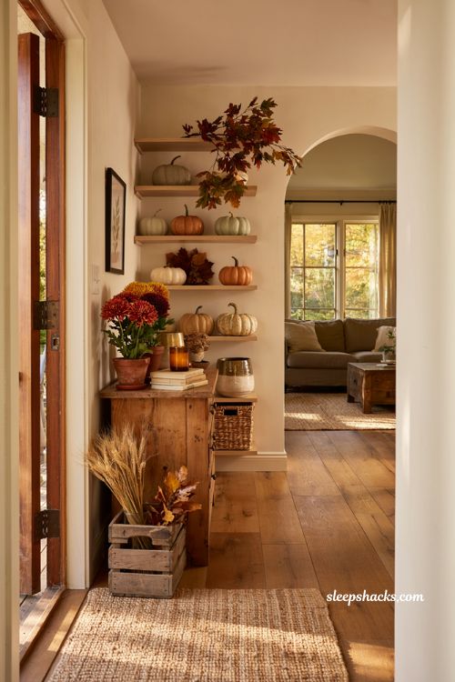Mix real and faux fall decor ideas for a cozy layered autumn entryway