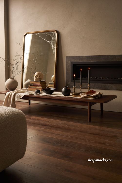 Modern Halloween decor with skull books spiderweb mirror and taper candles