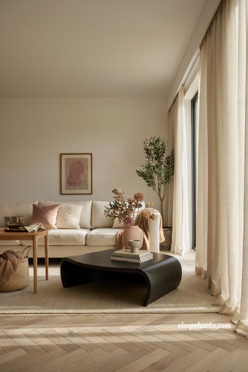 Modern fall decor ideas with blush pink accents in a contemporary living room