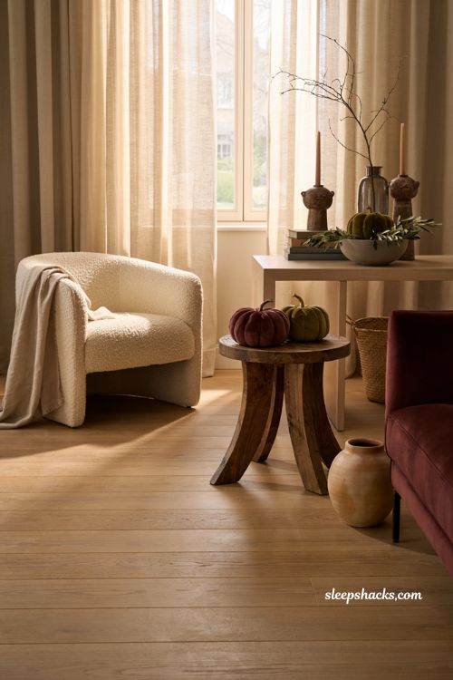 Modern fall decor ideas with burgundy velvet pumpkins in a contemporary living room