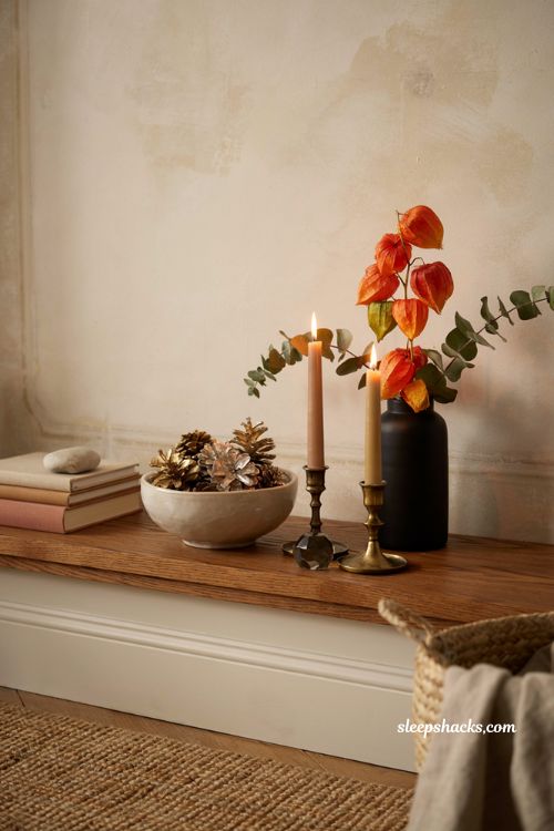 Modern fall decor ideas with metallic pine cones in a contemporary mantel display