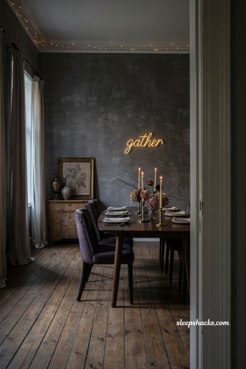 Modern gothic Halloween dining room with dark walls faded florals and moody lighting