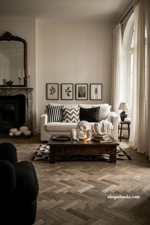 Monochrome Halloween living room decor with black and white skulls, ghosts, and cozy pillows 