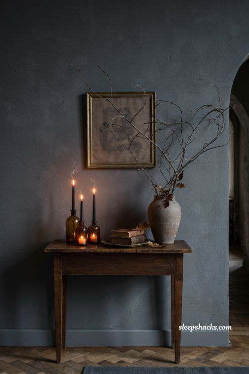 Moody Halloween entryway with amber candles black tapers and dark decor