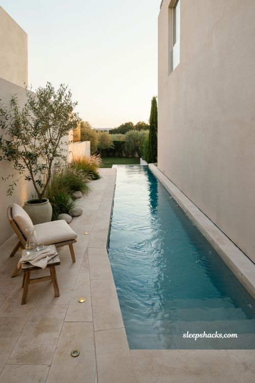 Narrow lap pool with infinity edge for small backyard