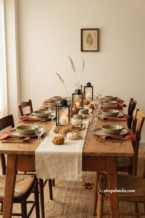 Neutral Halloween dining table decor with ceramic pumpkins terracotta napkins and autumn accents