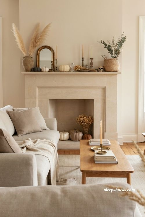 Neutral halloween decor with layered mantel dried blooms pumpkins and candles