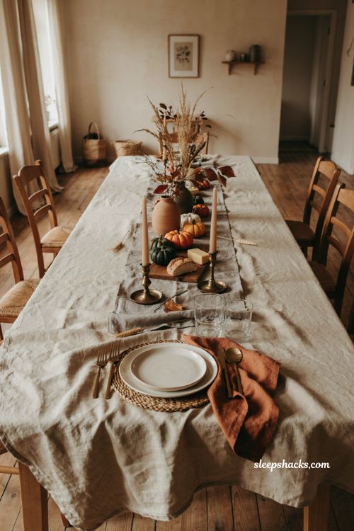 Neutral linen Thanksgiving table setting with cozy farmhouse autumn decor