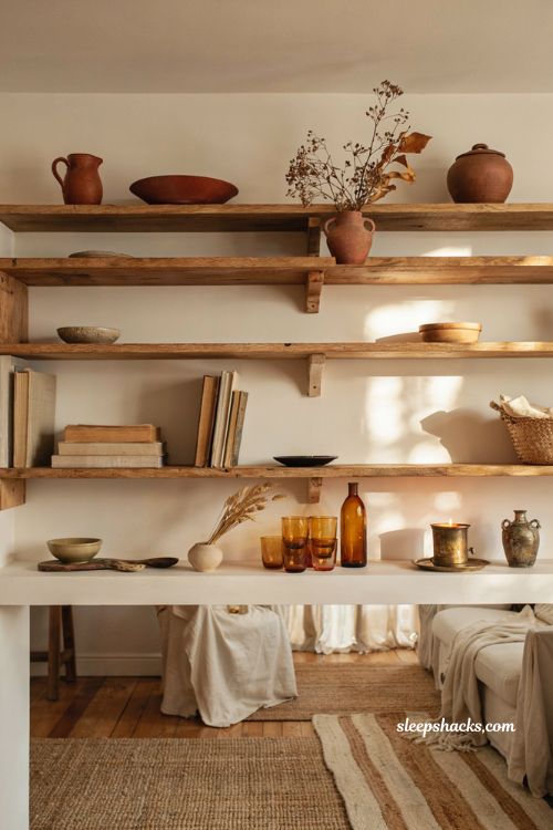 Open shelf fall vignette ideas with warm ceramics amber glass and cozy decor