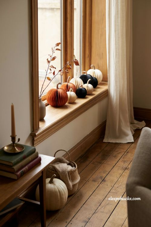 Origami paper pumpkins in orange black and white for Halloween window decor
