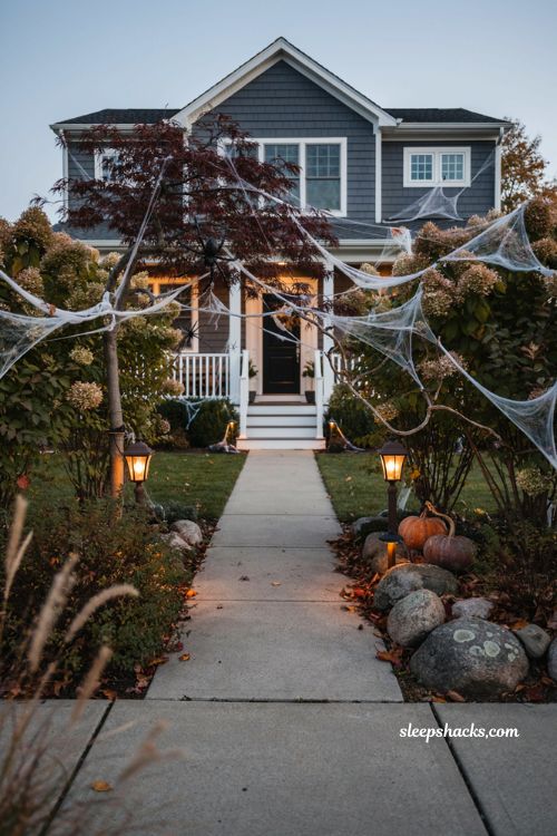 Outdoor Halloween decor front yards giant spiderweb bush ideas