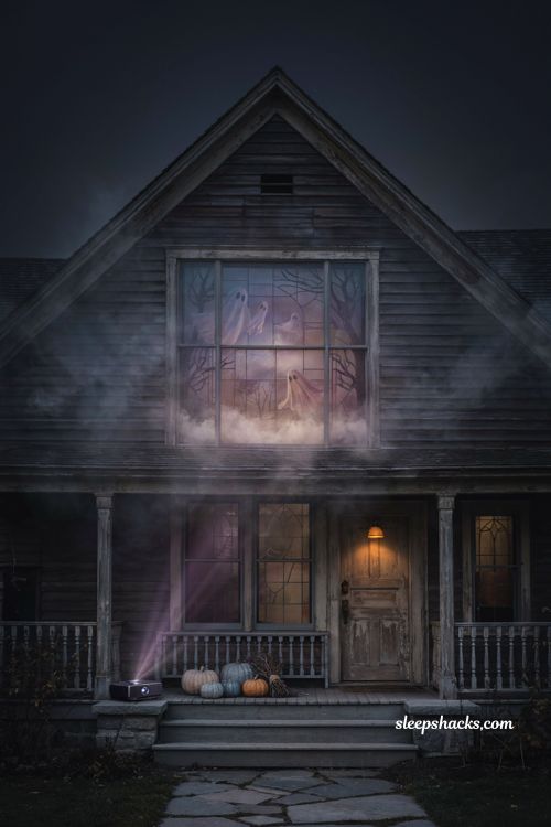 Outdoor Halloween window projection with glowing ghosts mist and cinematic haunted house effects