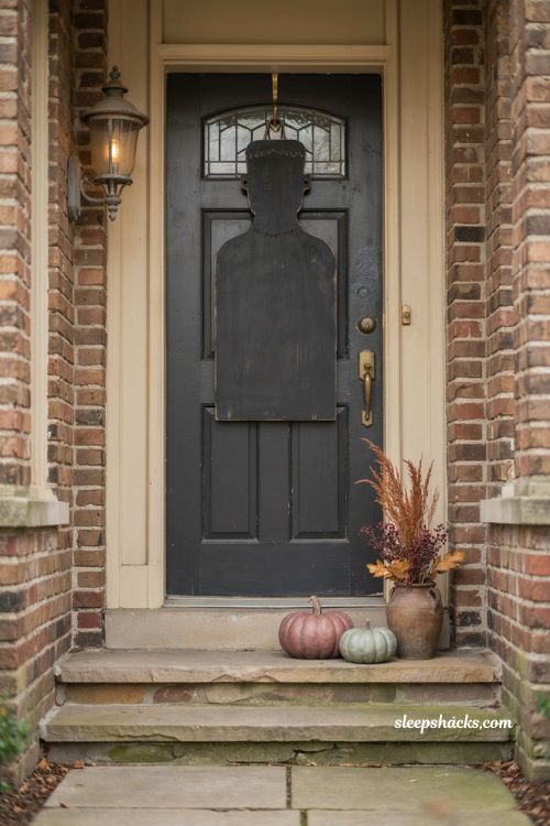 Oversized Halloween door hanger with Frankenstein character on a traditional front door