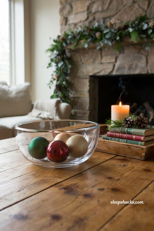 Oversized matte and glossy ornaments in glass bowl for a modern christmas coffee table decor idea