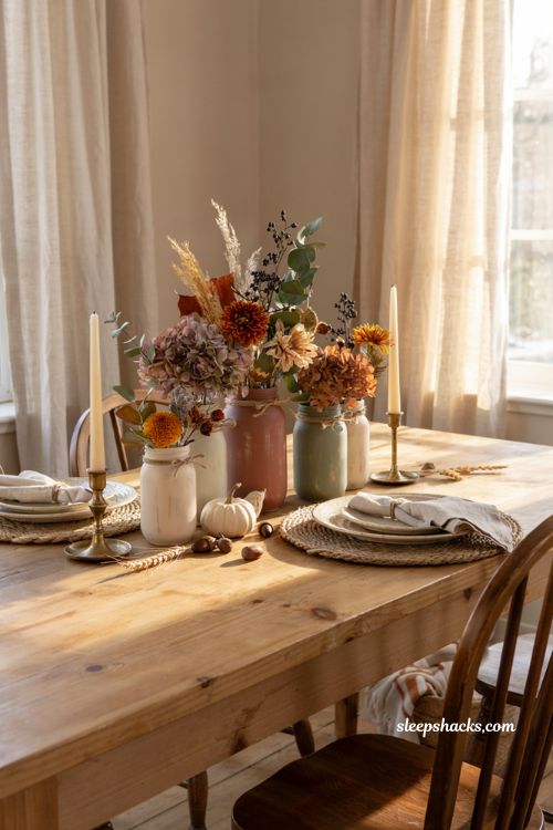Painted mason jar fall centerpiece with rustic autumn florals