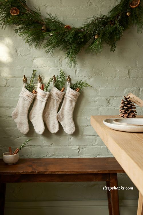 Personalized mini christmas stockings and pinecone place card ideas for cozy holiday guest entertaining