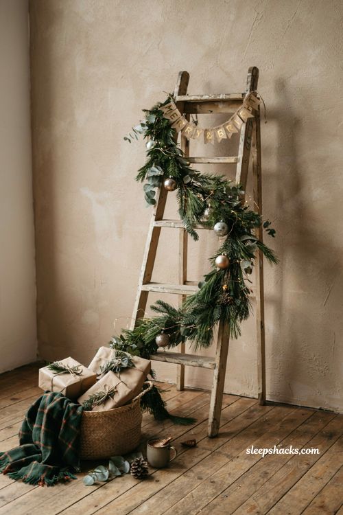 Photo worthy christmas party backdrop corner with decorated ladder garland lights and merry and bright banner