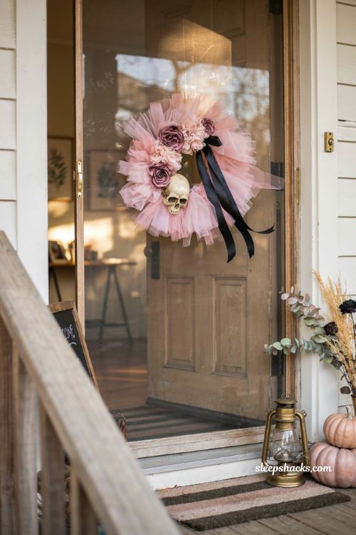 Pink Halloween wreath with black ribbon for a cozy fall front door