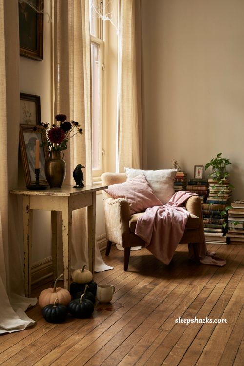 Pink halloween decor with blush pumpkins black accents and cozy vintage living room